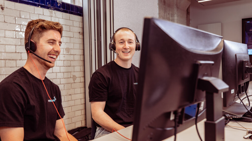 An image of two men talking on headsets in a call centre