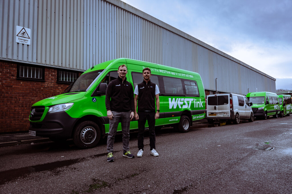 An image of the founders of WeMove in front of a minibus