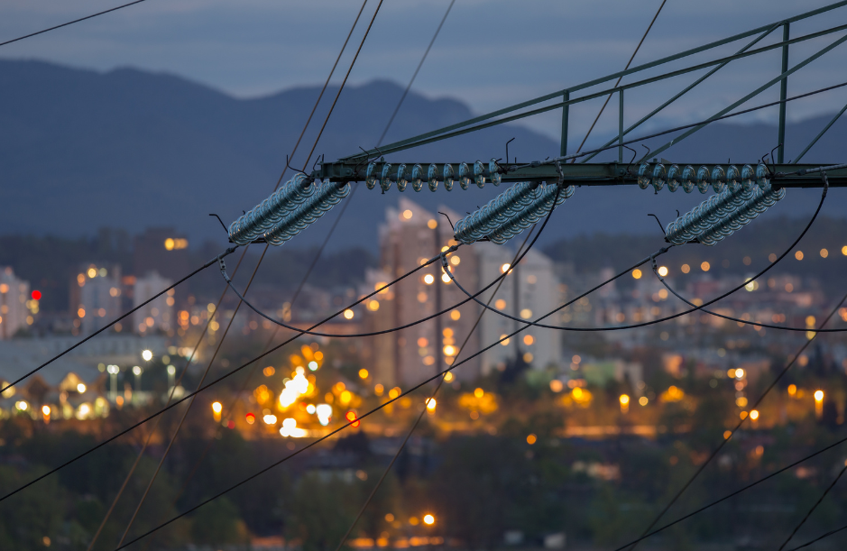 A power line over a lit up city at night