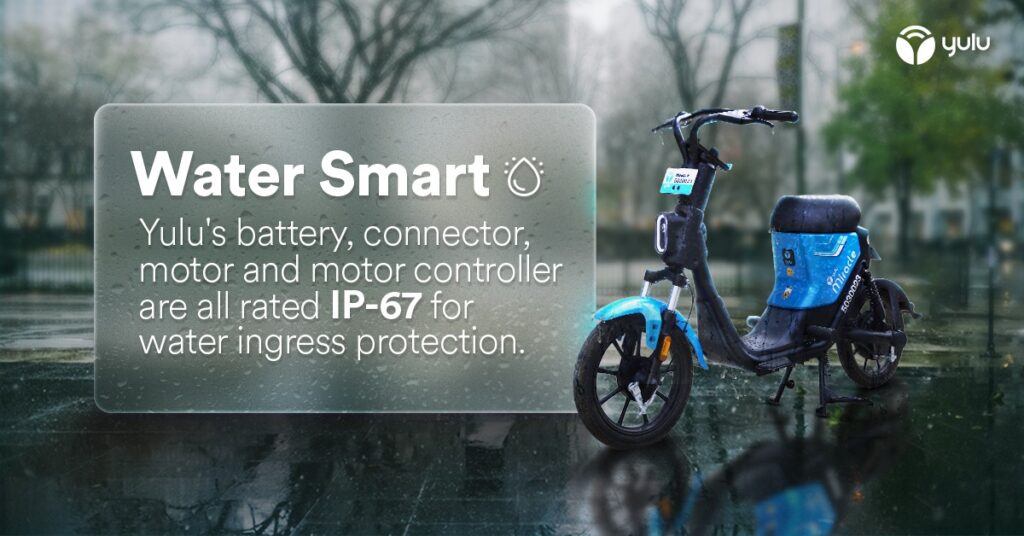 A blue two-wheeled electric vehicle in the rain