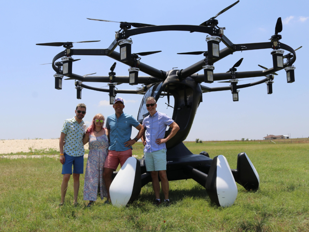 An image showing a group of four Beta pilots in front of a LIFT Aircraft eVTOL unit near Austin, Texas.