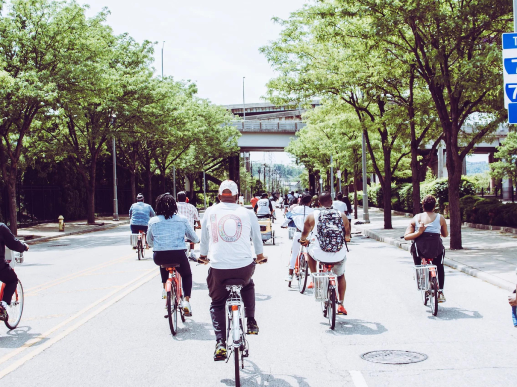 A group of people riding bicycles on a concrete road
