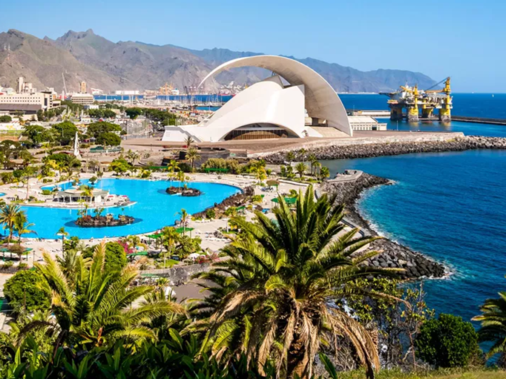 The city of Santa Cruz de Tenerife - a beautiful coastal city with bright blue water and a white sculptural building