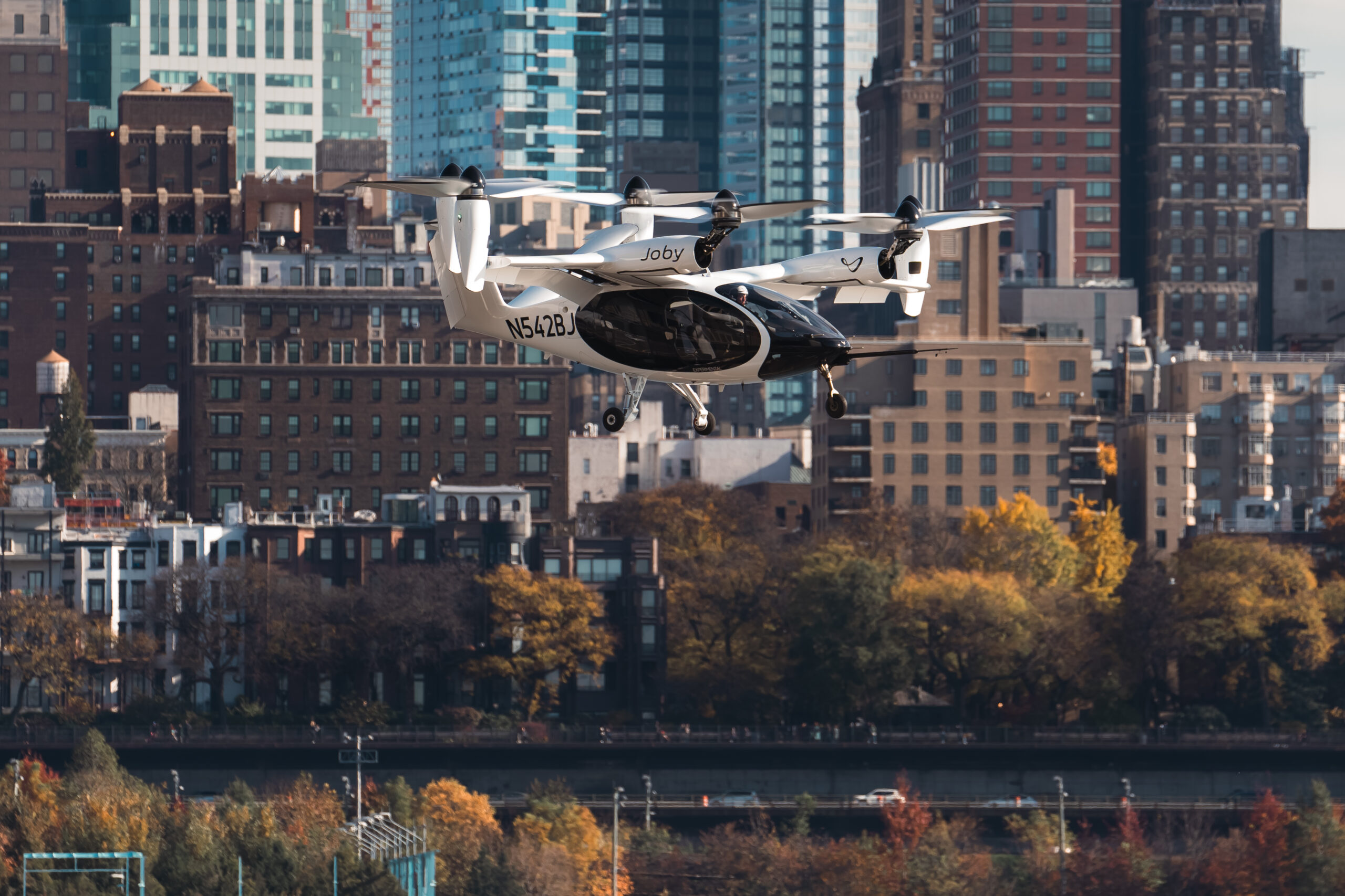 Joby’s electric air taxi in the skies above New York City, piloted by James “Buddy” Denham