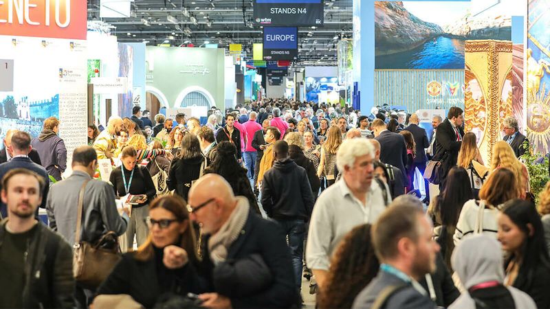 A crowd of people walking around an event