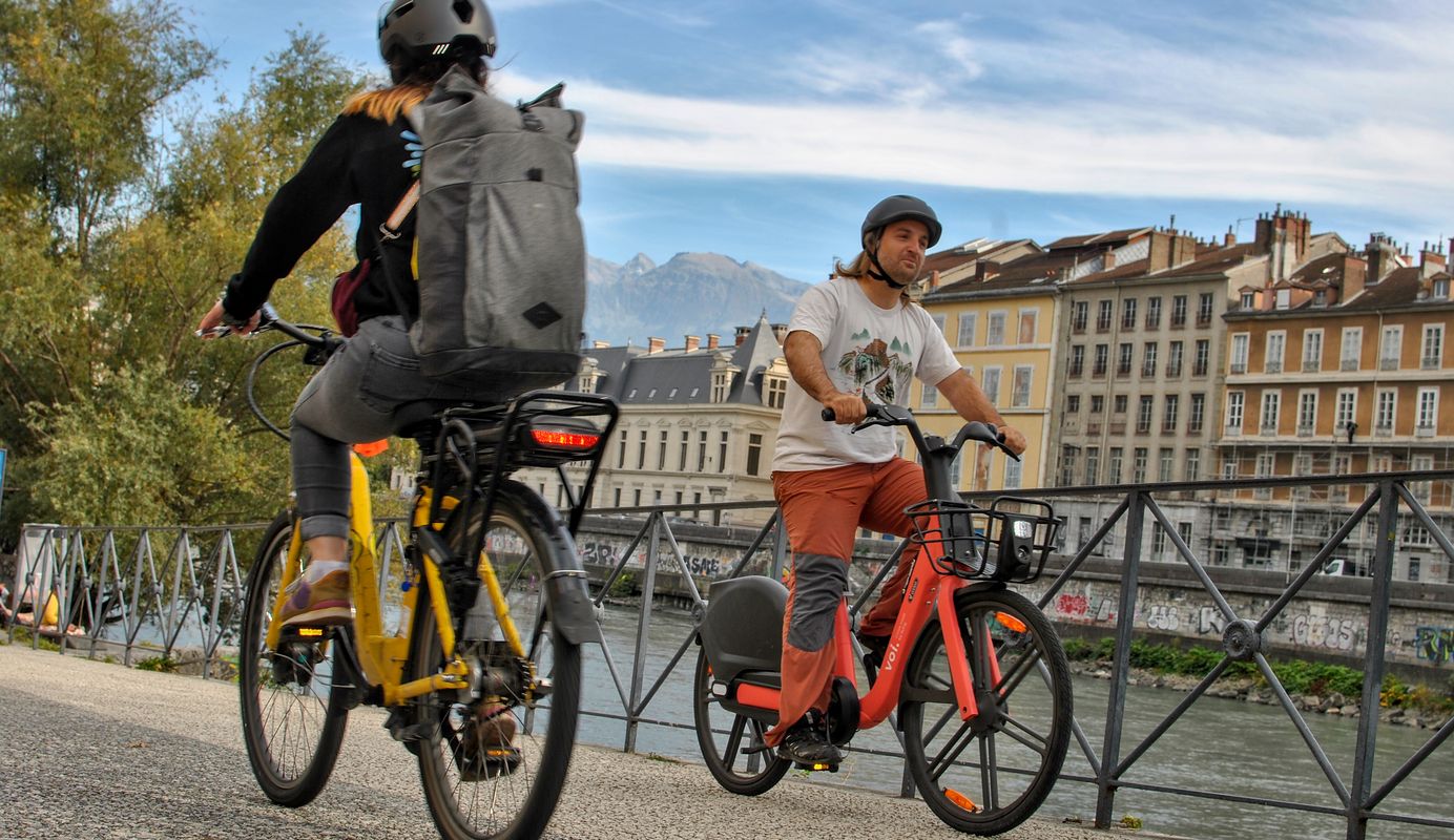 Two people riding on e-bikes