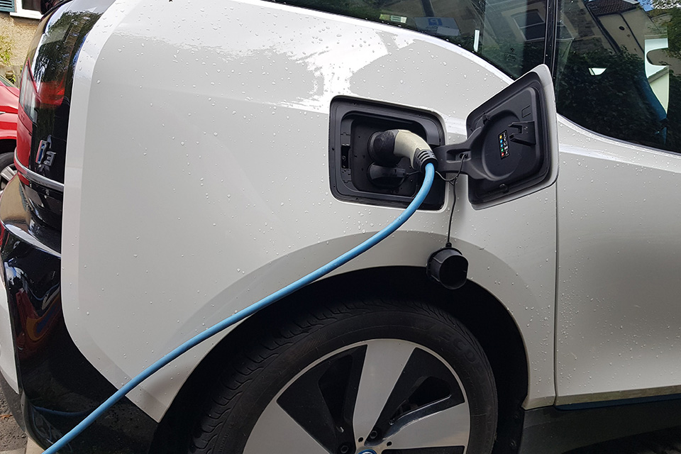 A car being charged via an EV charging port
