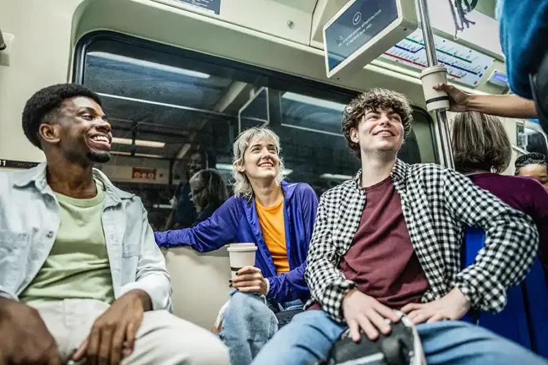 Commuters talking on subway
