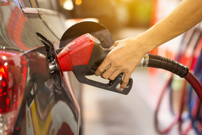 someone filling up fuel in a car