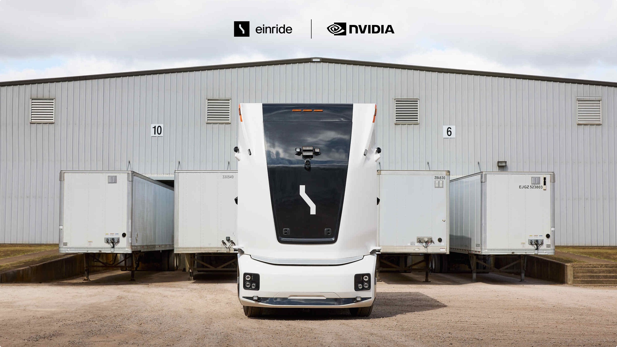 Einride autonomous electric truck parked at a loading dock, with the Einride and NVIDIA logos above