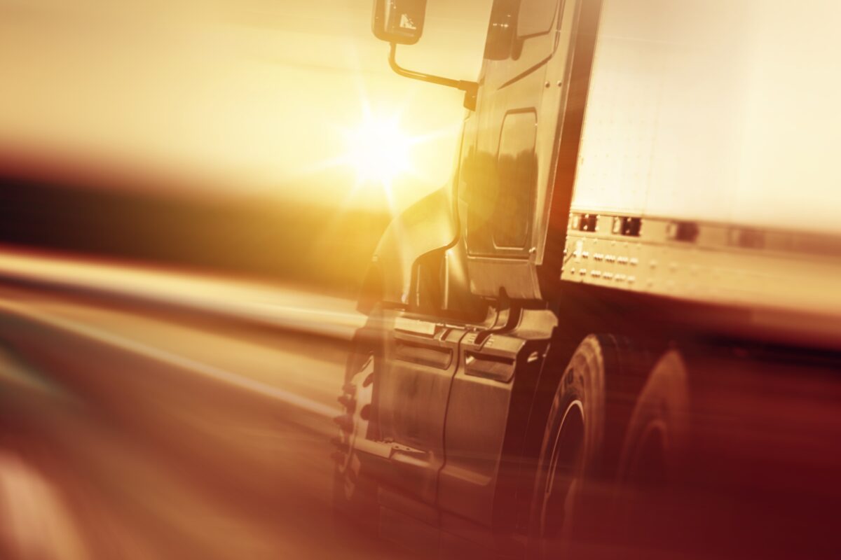 Truck on a highway at sunset, representing US commercial fleet safety