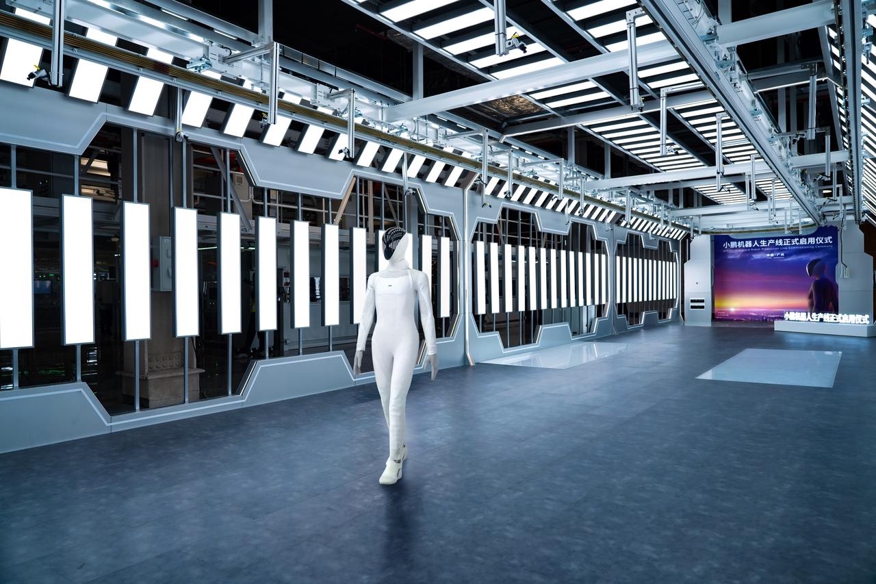 XPENG IRON humanoid robot walking through the company's robot production facility